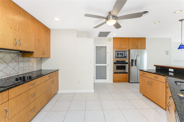 kitchen featuring visible vents, dark stone counters, light tile patterned flooring, appliances with stainless steel finishes, and tasteful backsplash