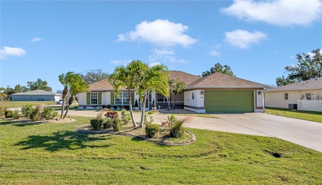 ranch-style home featuring cooling unit, a garage, and a front yard