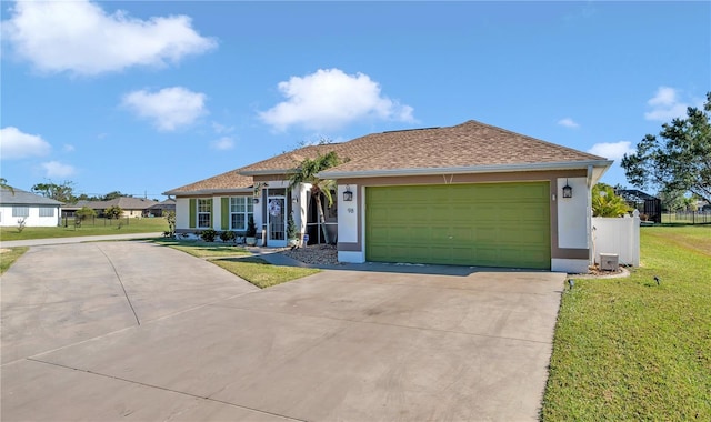 view of front of property featuring a garage and a front lawn