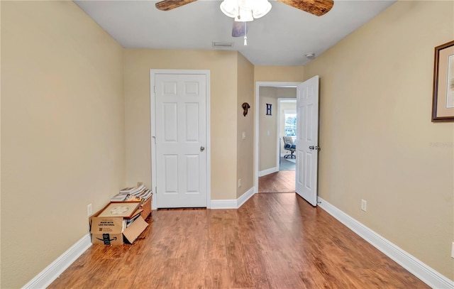 unfurnished room with hardwood / wood-style floors and ceiling fan