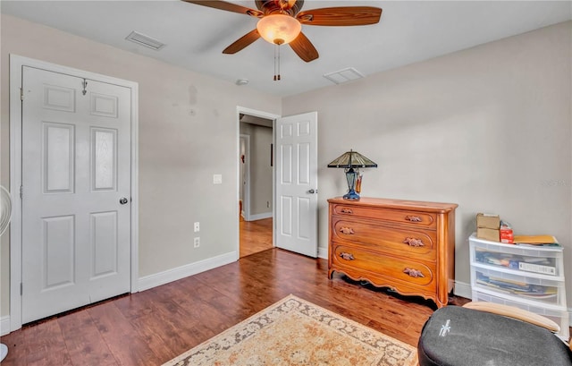 interior space featuring dark wood-type flooring and ceiling fan