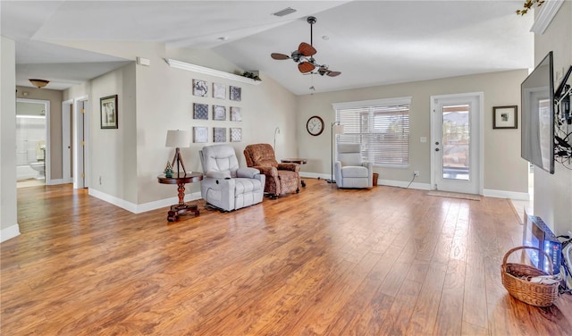 living area with hardwood / wood-style flooring, ceiling fan, and vaulted ceiling