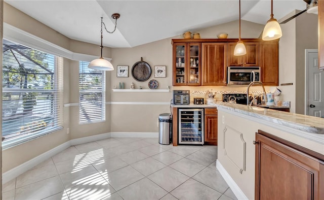 kitchen featuring wine cooler, light tile patterned floors, decorative light fixtures, and vaulted ceiling