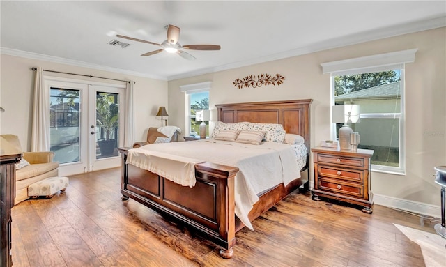 bedroom featuring ornamental molding, access to exterior, hardwood / wood-style floors, and multiple windows