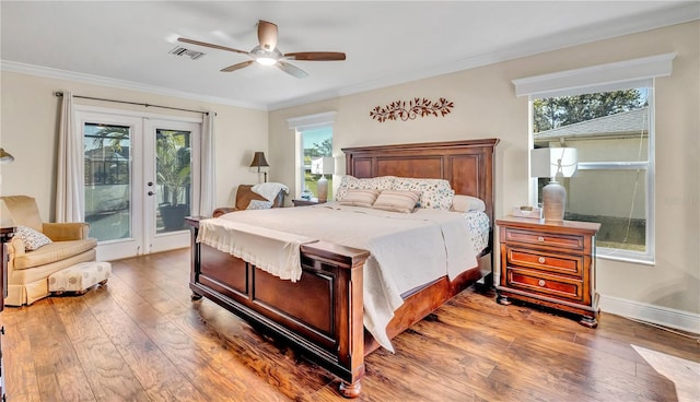 bedroom featuring crown molding, access to exterior, french doors, and hardwood / wood-style flooring