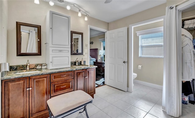 bathroom with vanity, toilet, and tile patterned flooring