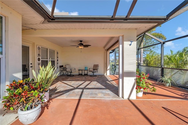 view of patio / terrace with ceiling fan and a lanai