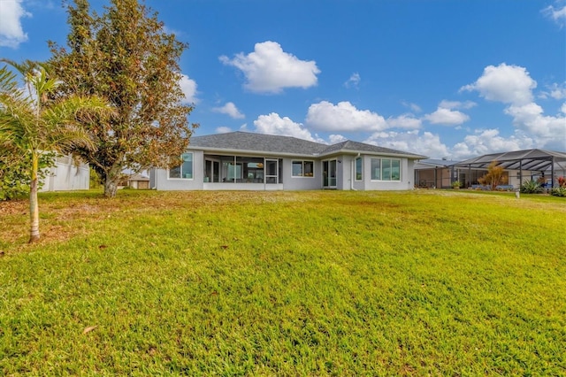 ranch-style home featuring a lanai and a front lawn