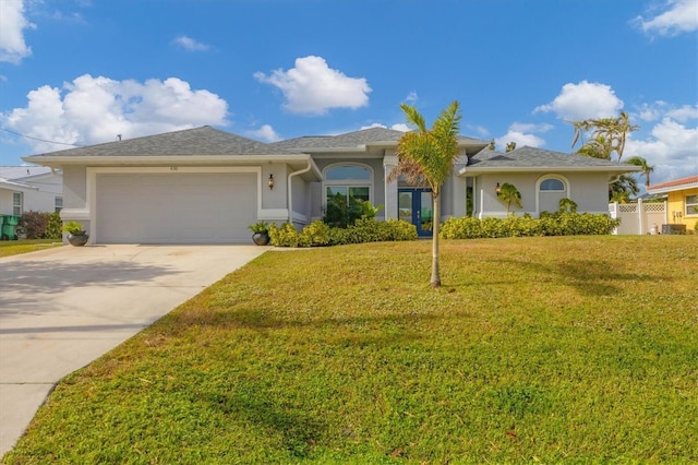 single story home featuring a garage and a front yard