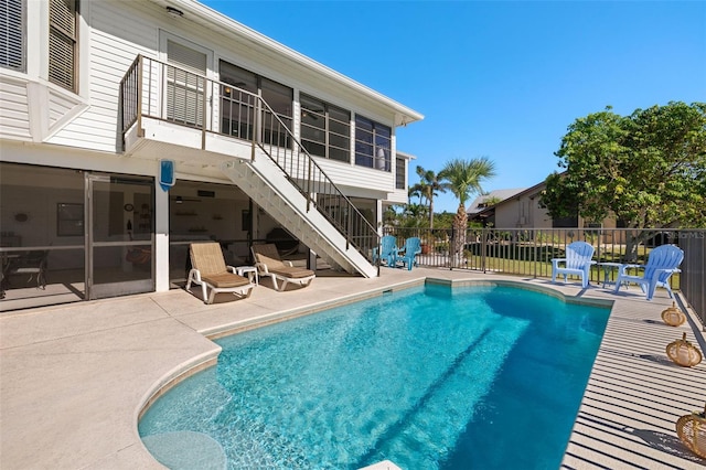 view of pool with a patio area and a sunroom