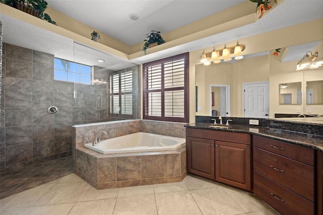 bathroom with tile patterned flooring, vanity, and separate shower and tub