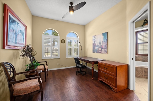 office area featuring a textured ceiling, dark hardwood / wood-style flooring, and ceiling fan