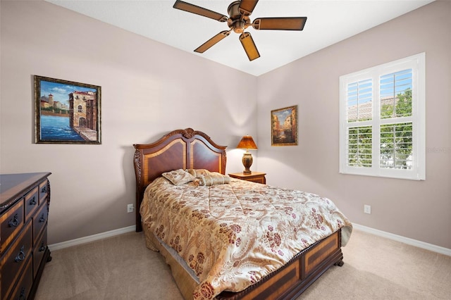 bedroom with ceiling fan and light carpet