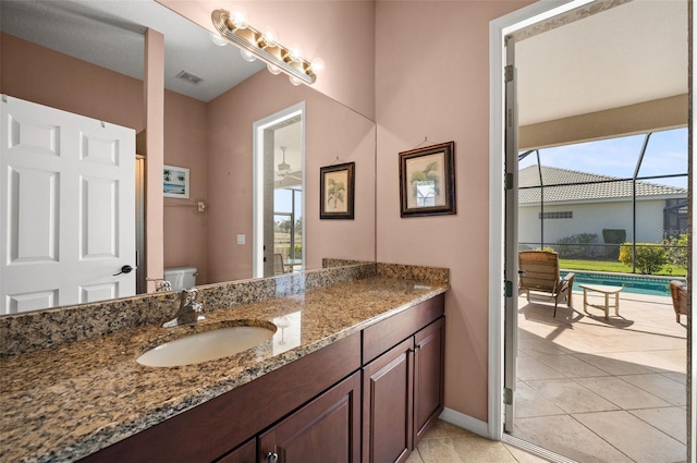 bathroom with tile patterned floors, vanity, toilet, and plenty of natural light