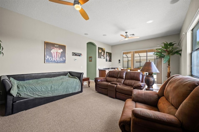 bedroom featuring carpet flooring, ceiling fan, and a textured ceiling