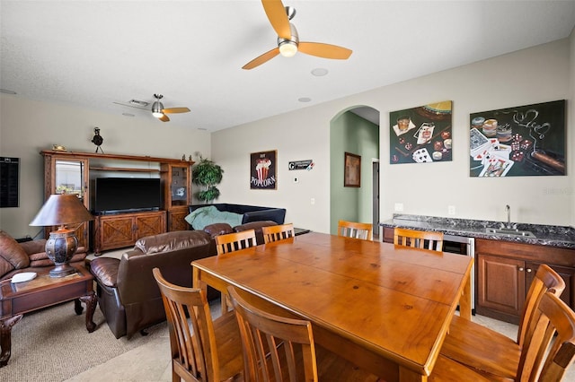 dining area featuring ceiling fan and sink