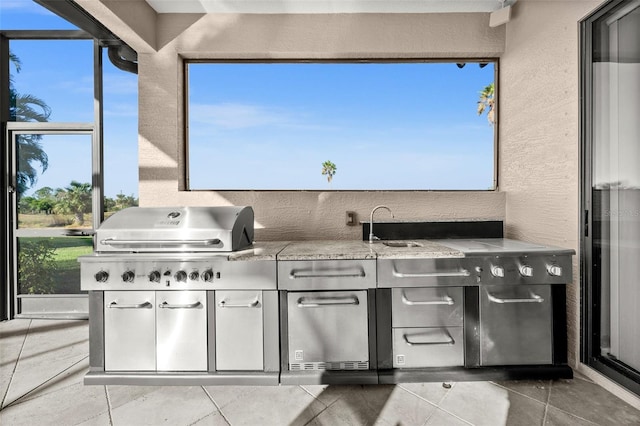 view of patio featuring a grill and sink