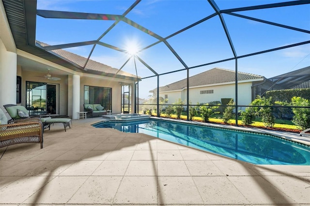 view of pool with a lanai, a patio area, ceiling fan, and an outdoor hangout area