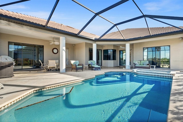 view of pool featuring outdoor lounge area, glass enclosure, ceiling fan, a grill, and a patio