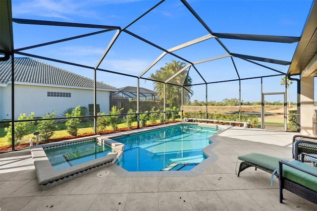 view of swimming pool with a lanai, an in ground hot tub, and a patio