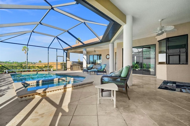 view of pool with a lanai, a patio area, and ceiling fan