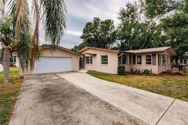 single story home featuring a front yard and a garage