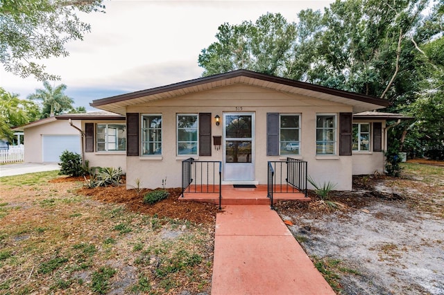 bungalow featuring a garage