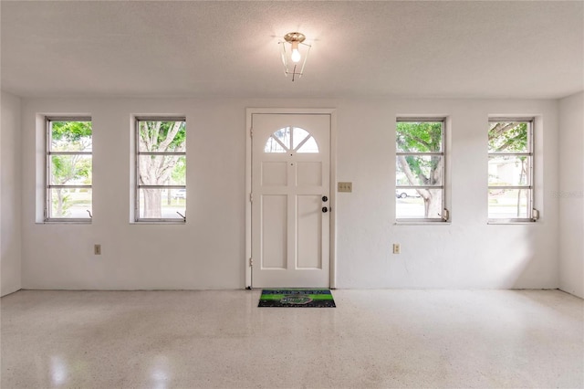 foyer entrance featuring a textured ceiling