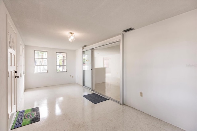 unfurnished room with a textured ceiling