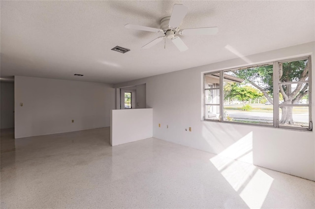 spare room featuring ceiling fan and a textured ceiling