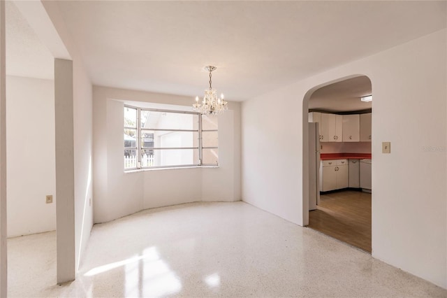 empty room featuring a notable chandelier