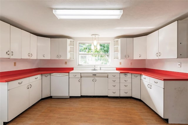 kitchen featuring sink, light hardwood / wood-style flooring, dishwasher, white cabinetry, and hanging light fixtures