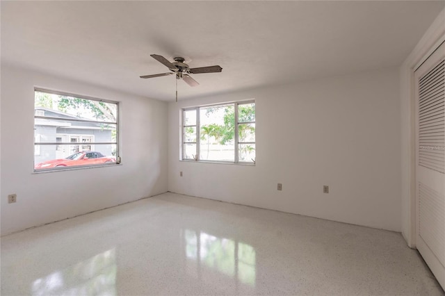 unfurnished bedroom featuring ceiling fan and a closet