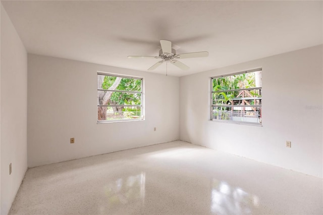 spare room with a wealth of natural light and ceiling fan