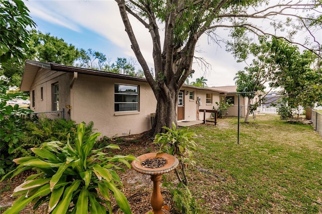 back of property featuring a lawn