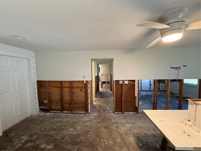 spare room with a textured ceiling and ceiling fan