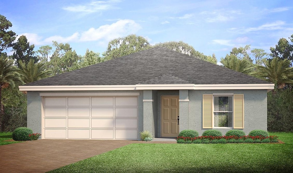 view of front of house featuring a front yard and a garage