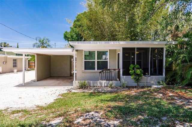 view of front of property featuring a carport and a sunroom