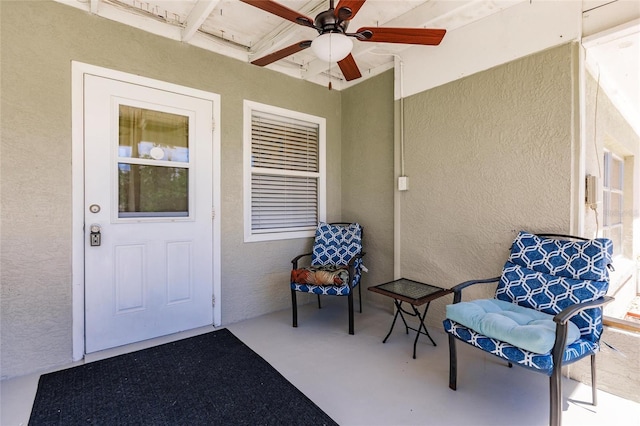 view of exterior entry featuring ceiling fan