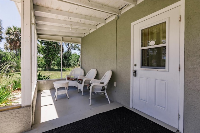 sunroom with beam ceiling