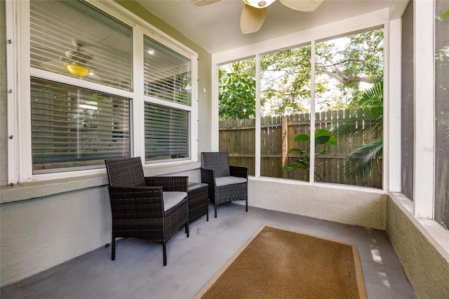 sunroom / solarium featuring ceiling fan