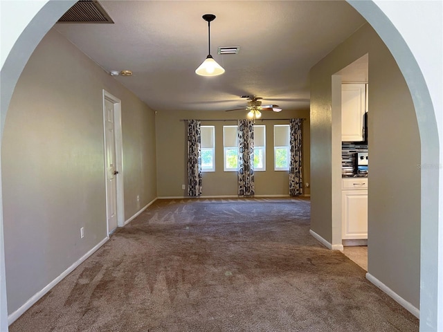 carpeted empty room with ceiling fan