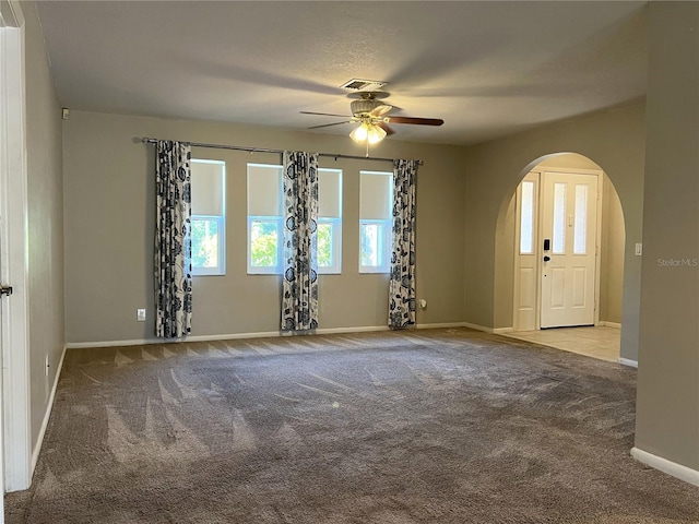 carpeted empty room featuring ceiling fan