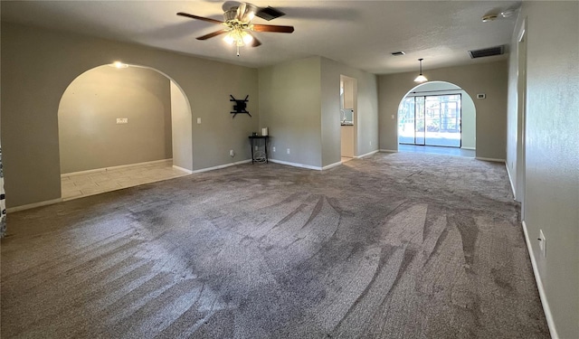 spare room featuring carpet flooring and ceiling fan