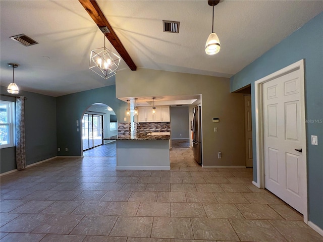 kitchen featuring plenty of natural light and hanging light fixtures