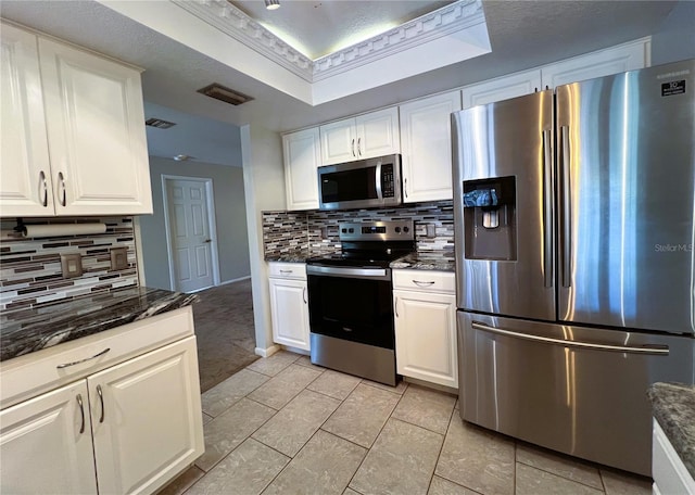1196 Hinton St, Port Charlotte, FL 33952 - kitchen with appliances with stainless steel finishes, backsplash, and white cabinets