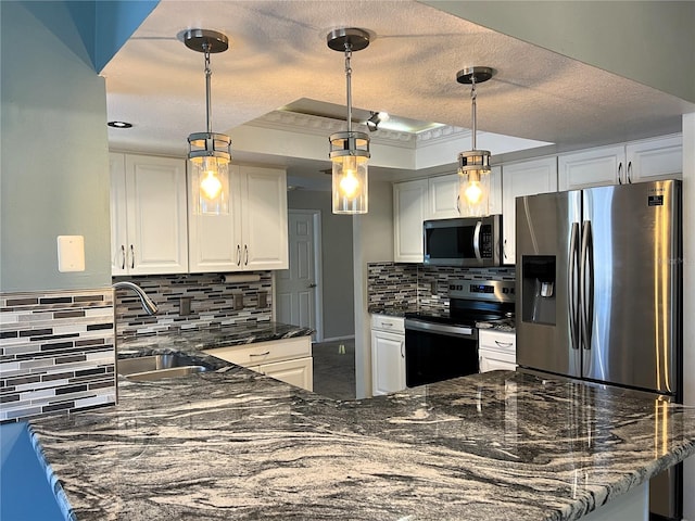 kitchen with white cabinets, decorative light fixtures, stainless steel appliances, and sink