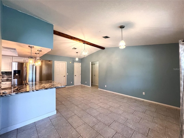 1196 Hinton St, Port Charlotte, FL 33952 - kitchen with stainless steel fridge, hanging light fixtures, dark stone countertops, and white cabinetry