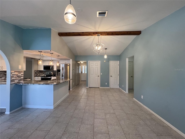 kitchen with vaulted ceiling with beams, hanging light fixtures, and appliances with stainless steel finishes