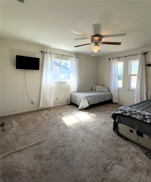 unfurnished bedroom featuring ceiling fan and carpet